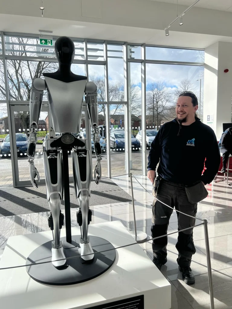 Blue Ape Renewables team member with Tesla Optimus robot